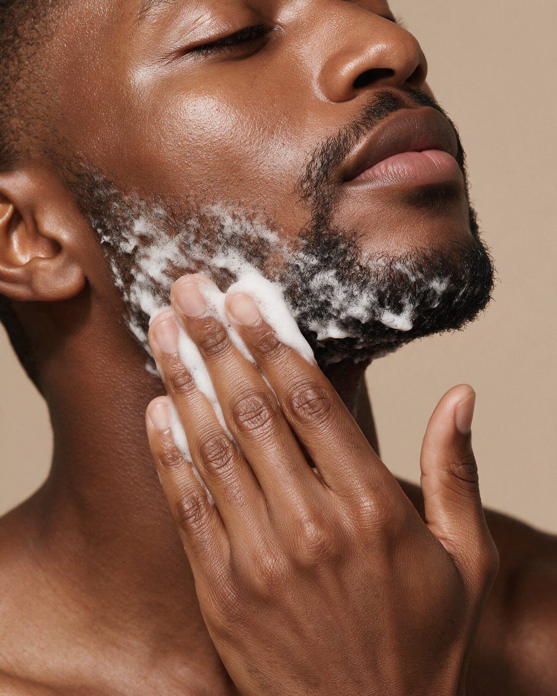 THE ROSE CONDITIONING WASH FOR MEN worked to a white lather along a short cropped beard and jawline, eyes closed.