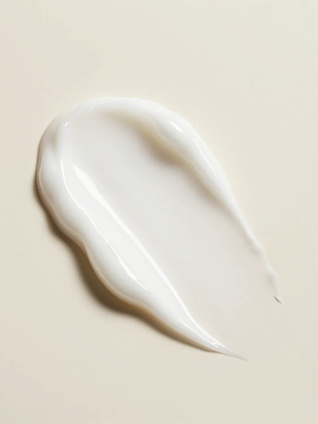 KOJIC ACID BRIGHTENING EXFOLIATOR, the texture of smooth white paste in close macro