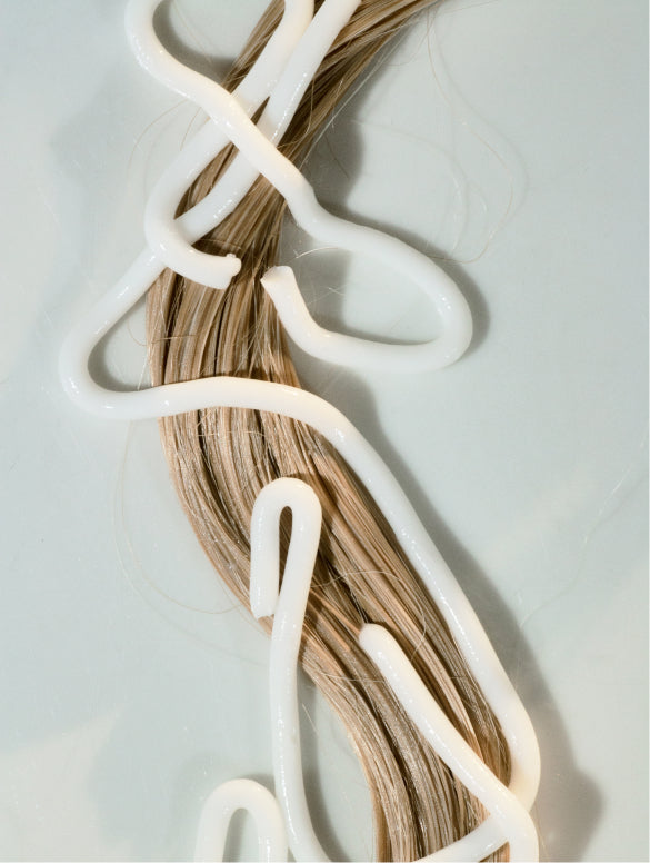 Strands of white product coiled on a grey ground, HIGH GLOSS CONDITIONER