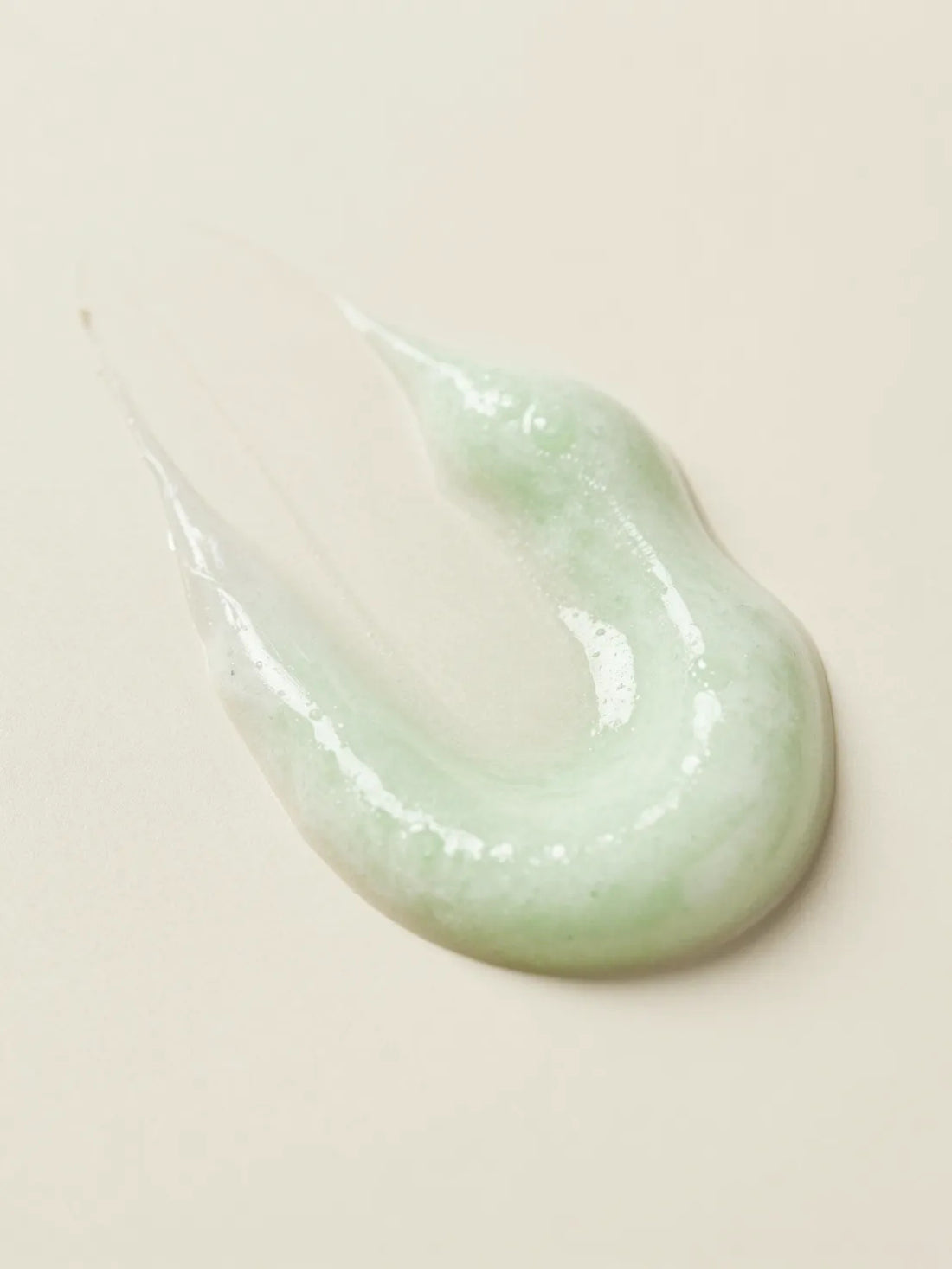 HIGH GLOSS SHAMPOO, the texture of pale green shampoo gel in close macro