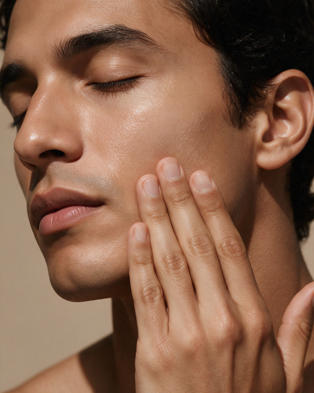 A man's fresh clean cheek and jaw with a light matte gel sheen, balanced