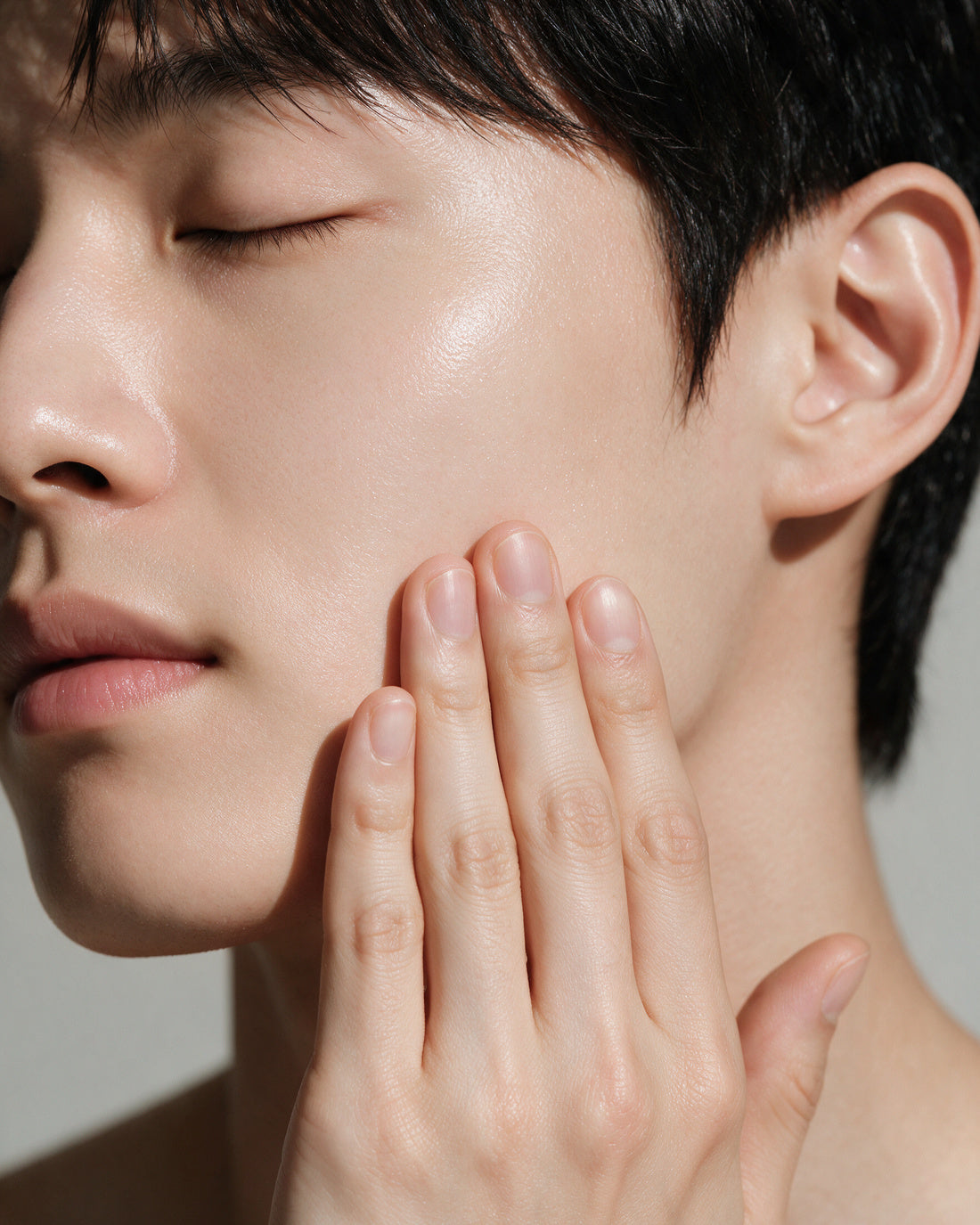 A man's fresh clean cheek and jaw with a light matte gel sheen, balanced